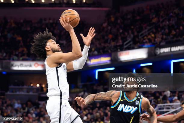 Trendon Watford of the Brooklyn Nets takes a shot over Obi Toppin of the Indiana Pacers during the first half at Gainbridge Fieldhouse on March 16,...