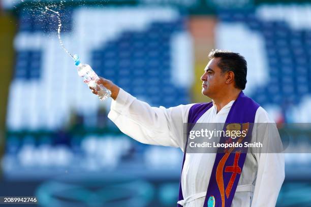 Father blesses the grass prior the 12th round match between Leon and Puebla as part of the Torneo Clausura 2024 Liga MX at Leon Stadium on March 16,...