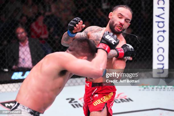 Christian Rodriguez punches Isaac Dulgarian in their featherweight fight during the UFC Fight Night event at UFC APEX on March 16, 2024 in Las Vegas,...