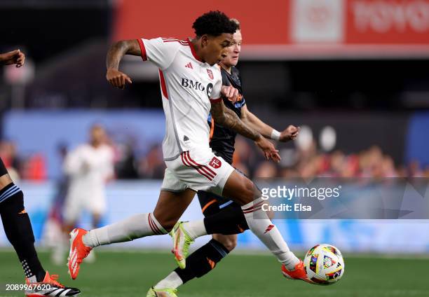 Jahkeele Marshall-Rutty of Toronto FC heads for the net and scores on this play as Mitja Ilenič of New York City FC defends during the first half at...