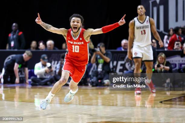 Jaelen House of the New Mexico Lobos celebrates as Jaedon LeDee of the San Diego State Aztecs looks on after New Mexico's win in the championship...