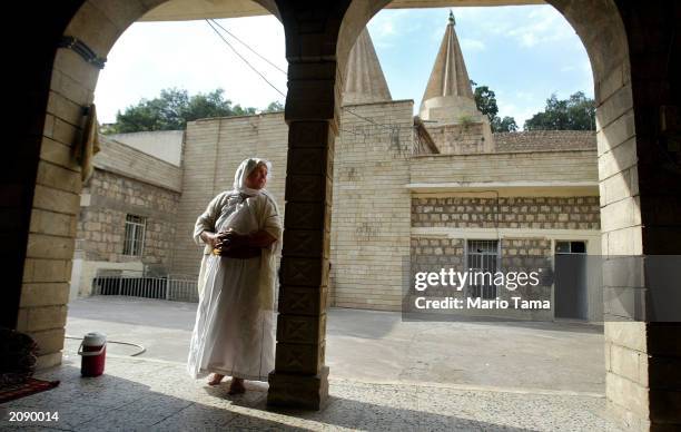 Kurdish woman of the ancient Yezidi religion stands outside the Sheik Adi shrine June 17, 2003 in Ain Sifni, Iraq. The Yezedi sect is an esoteric...