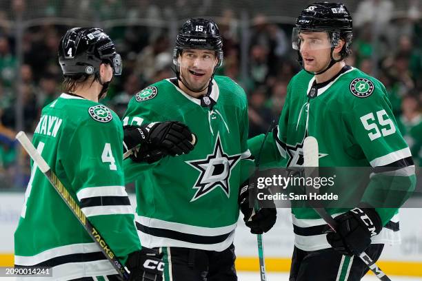 Craig Smith of the Dallas Stars is congratulated by Miro Heiskanen and Thomas Harley after scoring Smith scored a goal during the first period...