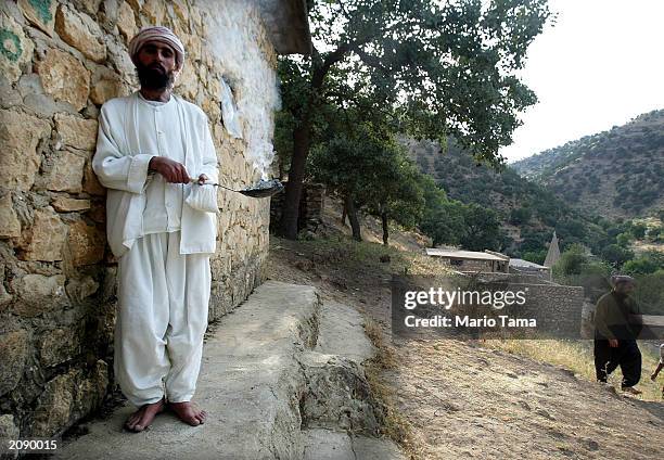 Kurdish woman of the ancient Yezidi religion stands outside the Sheik Adi shrine June 17, 2003 in Ain Sifni, Iraq. The Yezedi sect is an esoteric...