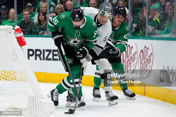 Matt Duchene and Mason Marchment of the Dallas Stars compete for the puck against Andreas Englund of the Los Angeles Kings during the first period at...