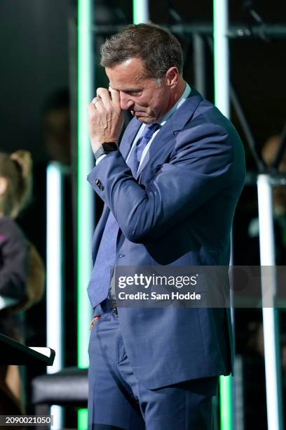 Former Dallas Stars player Mike Modano wipes his eye during a ceremony unveiling a statue honoring him in the first intermission of the game between...