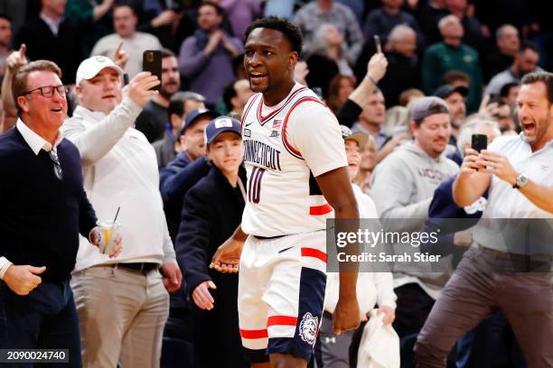 Hassan Diarra of the Connecticut Huskies celebrates with the crowd in the final seconds of the second half against the Marquette Golden Eagles during...