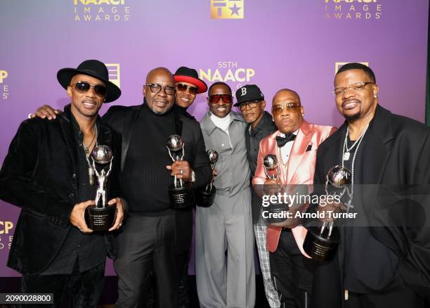 Brooke Payne poses with Ralph Tresvant, Bobby Brown, Ronnie DeVoe, Johnny Gill, Melle Mel, Michael Bivins, and Ricky Bell of New Edition, inducted...