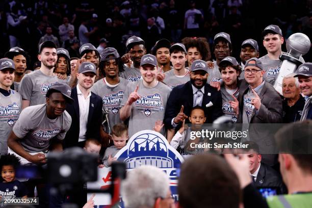 The Connecticut Huskies pose for a photo during the trophy ceremony after the game against the Marquette Golden Eagles during the Big East Basketball...