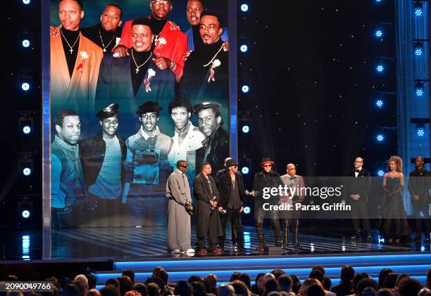Johnny Gill, Ricky Bell, Ralph Tresvant, Bobby Brown, Ronnie DeVoe and Michael Bivins of New Edition speak onstage during the 55th NAACP Image Awards...