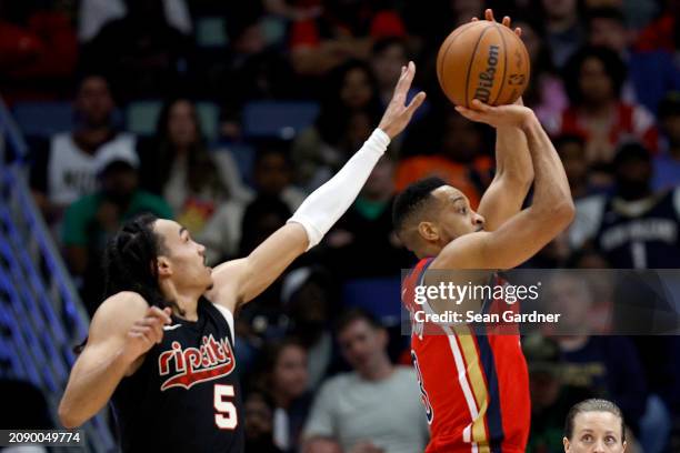 New Orleans Pelicans guard CJ McCollum shoot over Portland Trail Blazers guard Dalano Banton during the third quarter of an NBA game at Smoothie King...
