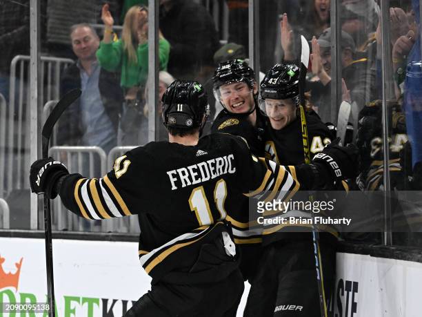 Danton Heinen of the Boston Bruins celebrates with Trent Frederic and Morgan Geekie after scoring a goal against the Philadelphia Flyers during the...