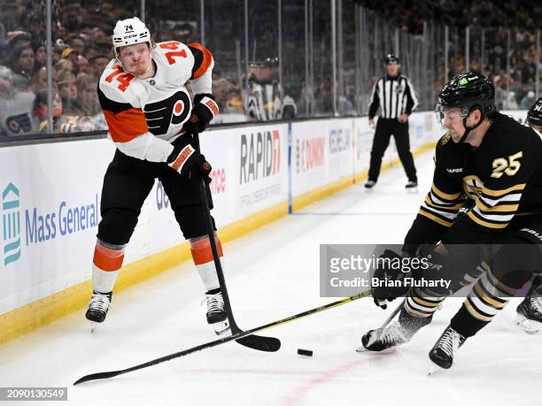 Owen Tippett of the Philadelphia Flyers passes the puck against Brandon Carlo of the Boston Bruins during the second period at the TD Garden on March...