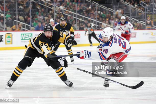 Chris Kreider of the New York Rangers takes a shot against Marcus Pettersson of the Pittsburgh Penguins at PPG PAINTS Arena on March 16, 2024 in...