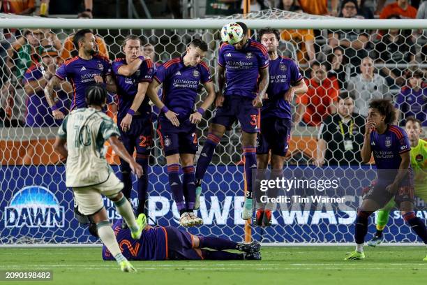 Micael of Houston Dynamo blocks a shot by Evander of Portland Timbers in the second half at Shell Energy Stadium on March 16, 2024 in Houston, Texas.