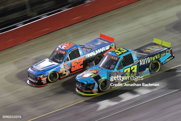 Stewart Friesen, driver of the Halmar International Toyota, and Lawless Alan, driver of the AUTOParkit Ford, race during the NASCAR Craftsman Truck...