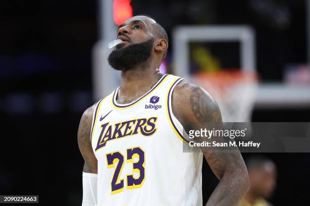 LeBron James of the Los Angeles Lakers looks on during a timeout as officials attempt to fix the shot clock during the second half of a game against...