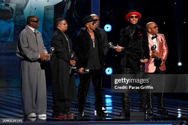 Johnny Gill, Ricky Bell, Ralph Tresvant, Bobby Brown, Ronnie DeVoe and Michael Bivins of New Edition speak onstage during the 55th NAACP Image Awards...