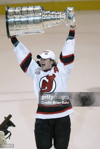 Patrik Elias of the New Jersey Devils holds up the Stanley Cup after beating the Mighty Ducks of Anaheim in game seven of the 2003 Stanley Cup Finals...