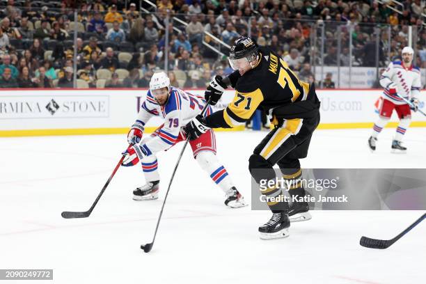 Evgeni Malkin of the Pittsburgh Penguins takes shot against K'Andre Miller of the New York Rangers at PPG PAINTS Arena on March 16, 2024 in...