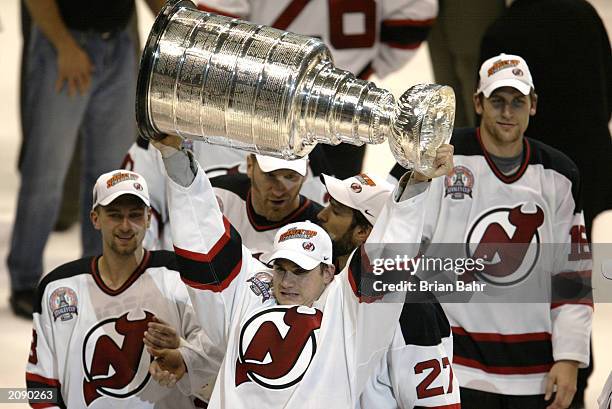 Jamie Langenbrunner of the New Jersey Devils raises the Stanley Cup as he celebrates the win over the Mighty Ducks of Anaheim in game seven of the...