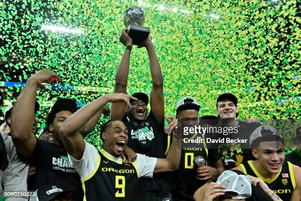 The Oregon Ducks celebrate their victory over the Colorado Buffaloes after the championship game in the Pac-12 basketball tournament at T-Mobile...