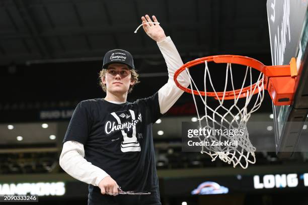 Maddox Monson of the Long Beach State 49ers cuts the net after defeating UC Davis Aggies in the championship game of the Big West Conference men's...