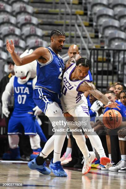 Ray Harrison of the Grand Canyon Antelopes tries to keep the ball inbounds against Shemar Wilson of the Texas-Arlington Mavericks in the first half...