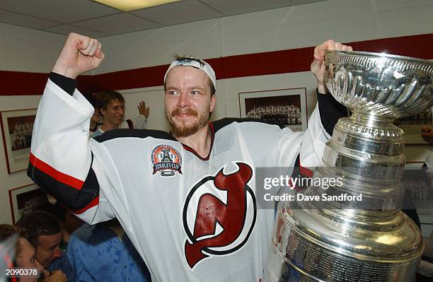 Turner Stevenson of the New Jersey Devils celebrates with the Stanley Cup in the locker room after defeating the Mighty Ducks of Anaheim in game...