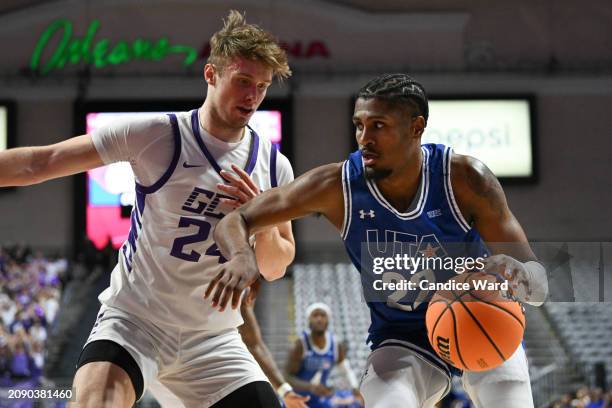 Shemar Wilson of the Texas-Arlington Mavericks dribbles against Duke Brennan of the Grand Canyon Antelopes in the first half of the championship game...