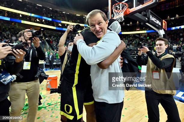 Head coach Dana Altman of the Oregon Ducks hugs Kwame Evans Jr. #10 after their victory over the Colorado Buffaloes in the championship game in the...