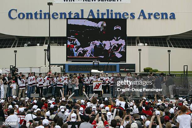Members of the New Jersey Devils present the Stanley Cup as the Devils celebrate their Stanley Cup championship with their fans in the parking lot at...