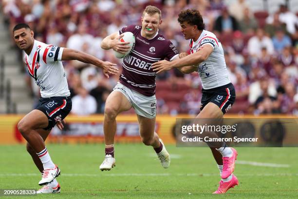 Tom Trbojevic of the Sea Eagles attempts to evade the tackle of Daniel Tupou and Joseph-Aukuso Suaalii of the Roosters during the round two NRL match...