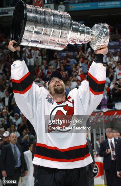 Scott Stevens of the New Jersey Devils holds up the Stanley Cup after beating the Mighty Ducks of Anaheim in game seven of the 2003 Stanley Cup...