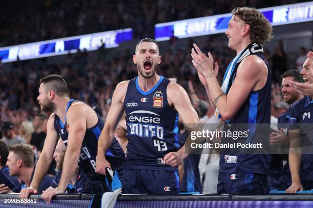 Chris Goulding of United celebrates with Matthew Dellavedova of United and Luke Travers of United during game one of the NBL Championship Grand Final...