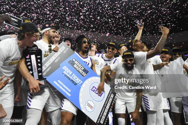 The Grand Canyon Antelopes place a team sticker on a ceremonial ticket after defeating the Texas-Arlington Mavericks 89-74 in the championship game...