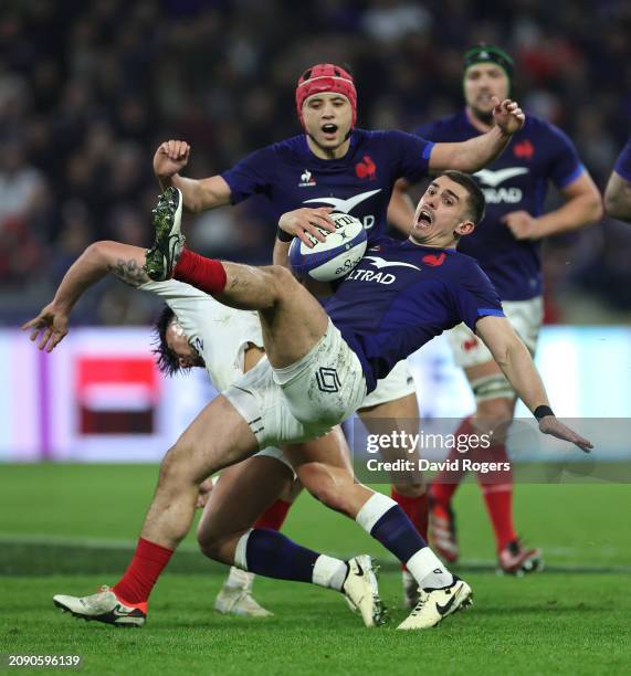 Thomas Ramos of France is upended by Marcus Smith during the Guinness Six Nations 2024 match between France and England at Groupama Stadium on March...