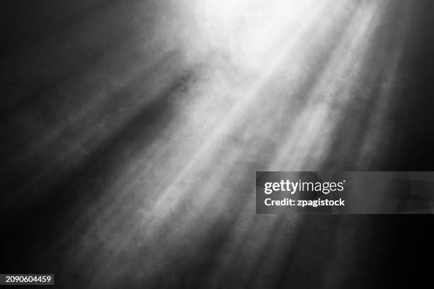 smoke against black background with light rays and beams - raio de luz imagens e fotografias de stock