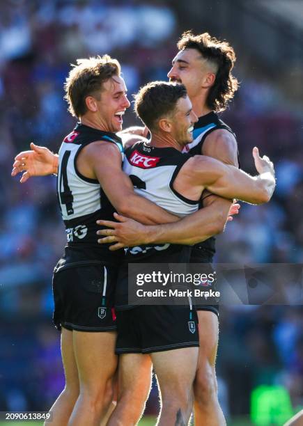 Kane Farrell of the Power celebrates a goal with Ivan Soldo and Jackson Mead of the Power during the round one AFL match between Port Adelaide Power...