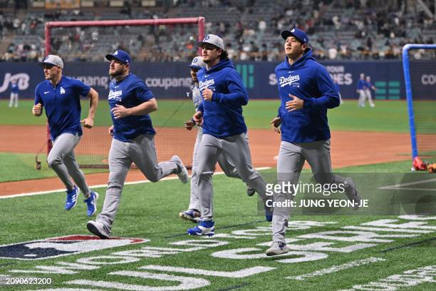 Los Angeles Dodgers' Shohei Ohtani warms up during practice at the Gocheok Sky Dome in Seoul on March 20 ahead of the 2024 MLB Seoul Series baseball...