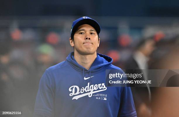 Los Angeles Dodgers' Shohei Ohtani warms up during practice at the Gocheok Sky Dome in Seoul on March 20 ahead of the 2024 MLB Seoul Series baseball...