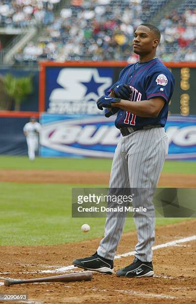 Left fielder Jacque Jones of the Minnesota Twins removes his batting gloves after striking out for the third out in the third inning during the...
