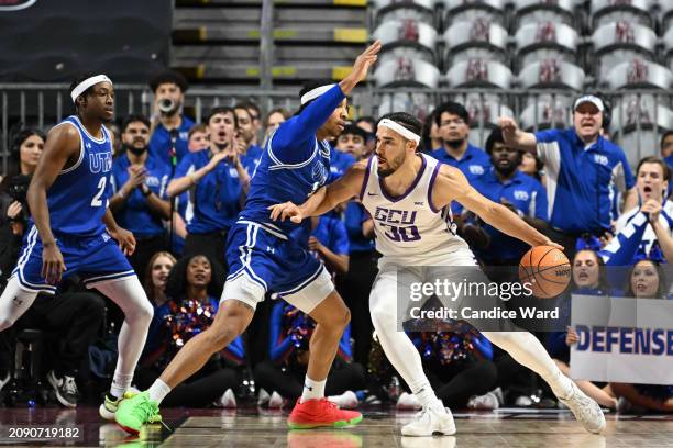 Aaron Cash of the Texas-Arlington Mavericks defends Gabe McGlothan of the Grand Canyon Antelopes in thefirst half of the championship game of the...