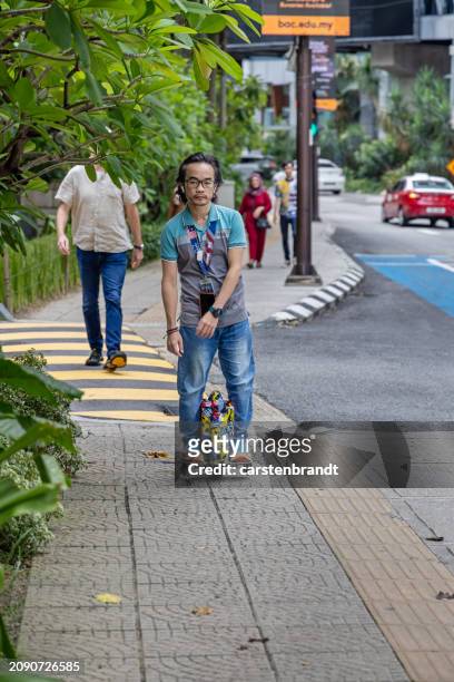 young man on a electric monowheel - monowheel stockfoto's en -beelden
