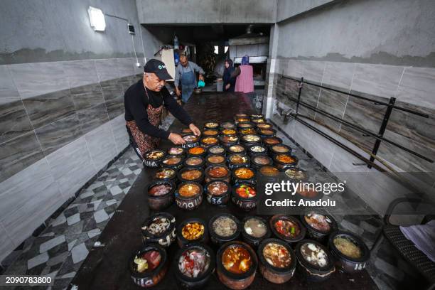 The casseroles of different sizes brought by housewives according to the number of people in the family are placed in the oven while the ovens in the...