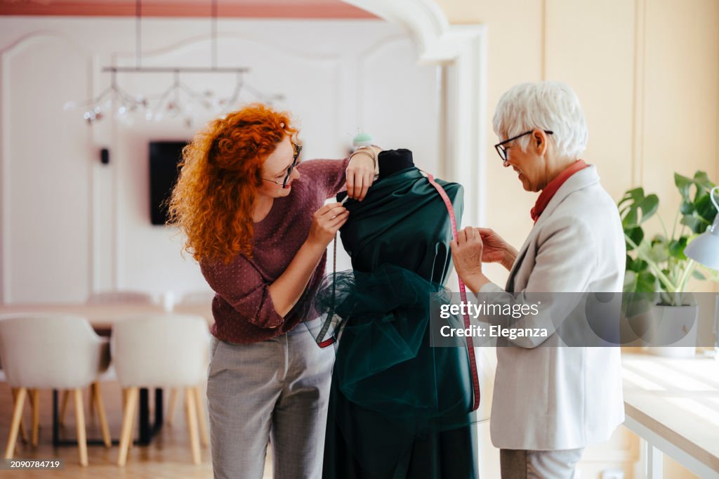 Two female fashion designer working on new fashion collection