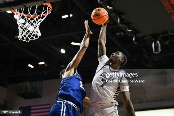 Tyon Grant-Foster of the Grand Canyon Antelopes drives to the basket against Shemar Wilson of the Texas-Arlington Mavericks in the second half of the...