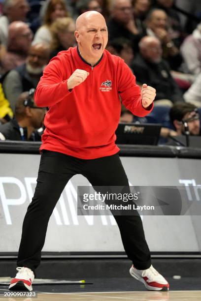 Head coach Geno Ford of the Stony Brook Seawolves cheers during the championship of the CAA Mens Basketball Tournament against the Charleston Cougars...