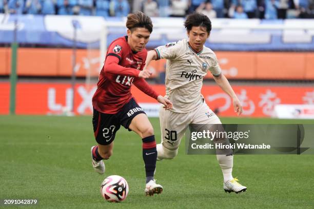 Yuta Matsumura of Kashima Antlers and Yusuke Segawa of Kawasaki Frontale compete for the ball during the J.LEAGUE MEIJI YASUDA J1 4th Sec. Match...