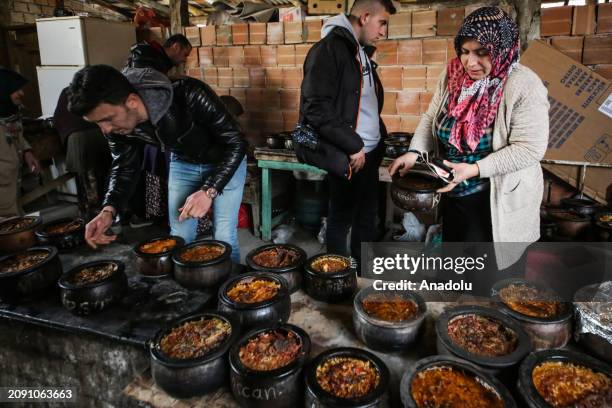 The casseroles of different sizes brought by housewives according to the number of people in the family are placed in the oven while the ovens in the...